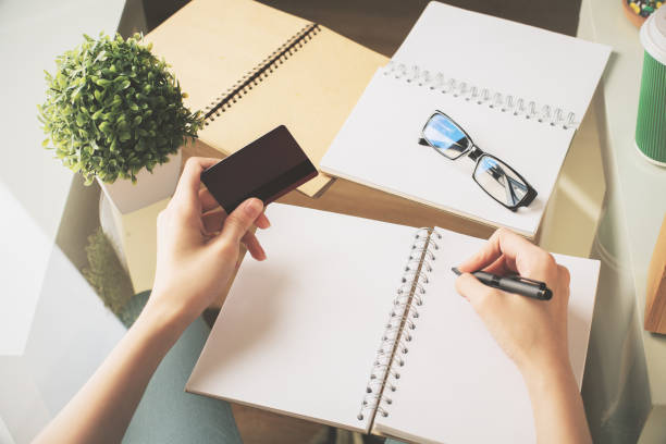istock Woman copying information from card 803406396
