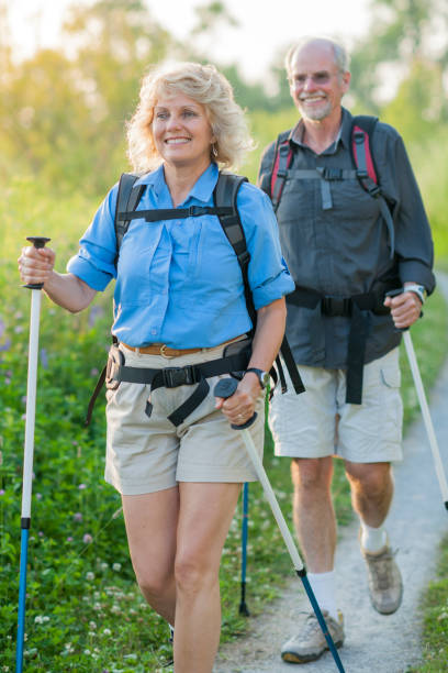 istock Senior Couple Walking with Trekking Poles 803412830