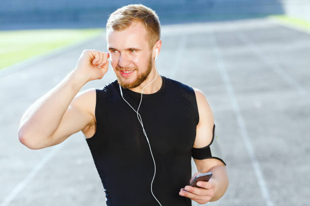 istock Man listening to music on stadium 803432630