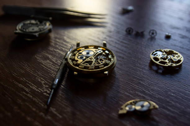 istock A watch maker is repairing a vintage automatic watch. 803435060