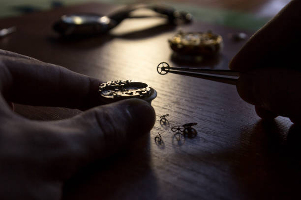 istock A watch maker is repairing a vintage automatic watch. 803435098