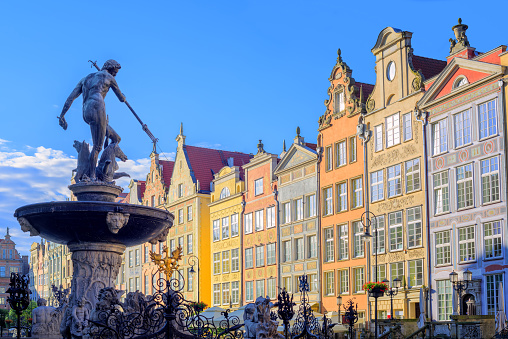 Neptune fountain statue in Gdansk with colorful gothic houses in the background, Poland