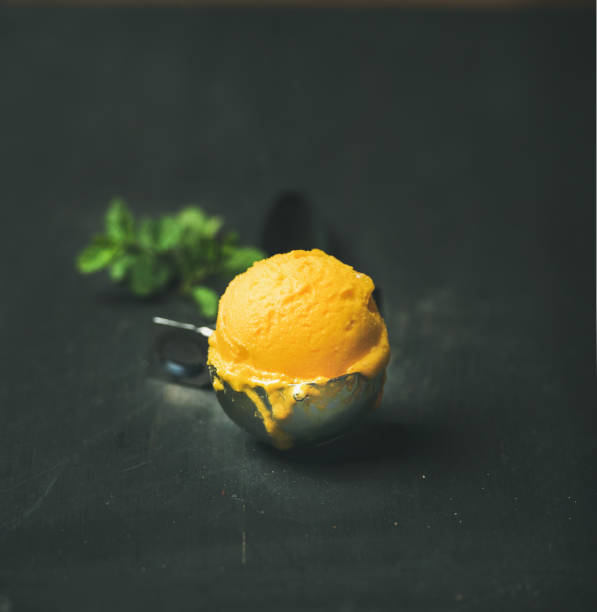 istock Mango sorbet ice cream scoop, square crop, copy space 803462256