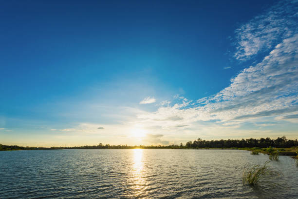istock Beautiful sunset landscape with blue sky over lake 803468966