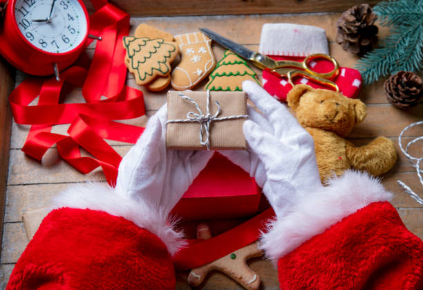 istock Santa Claus have wrapping a Christmas present box 803469172