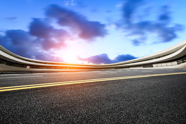 istock asphalt road and modern architecture at sunset 803479804