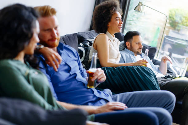 istock Group of friends watching TV, drinking cider  and having fun 803488054