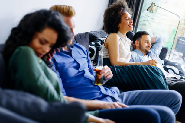 istock Group of friends watching TV, drinking cider  and having fun 803488058