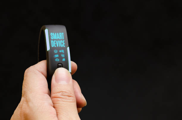 istock Close up hand holding smart watch to control feature with blank black background,Smart device concept.Mock up for adding your content or design 803488356