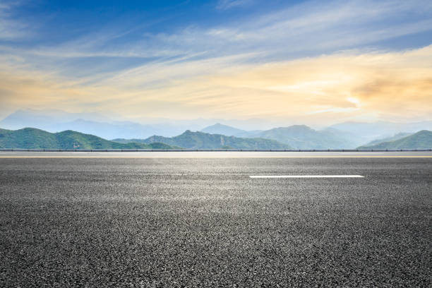 istock asphalt road and mountain background 803490804