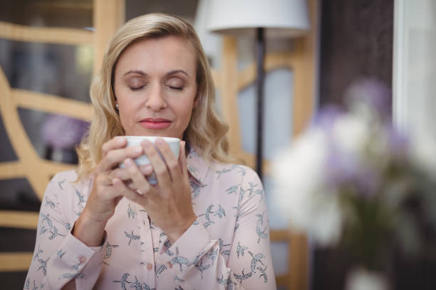 istock Beautiful woman smelling black coffee 803494650