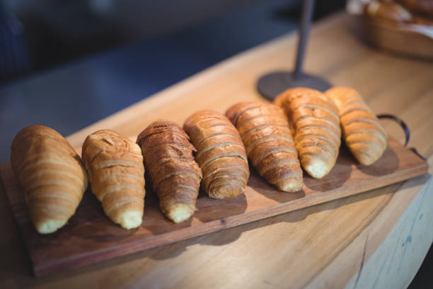istock Croissants arranged on wooden tray at counter 803497422
