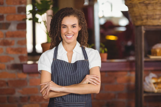 istock Smiling barista with arms crossed 803497580