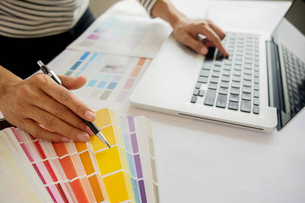 istock Graphic design and color swatches and pens on a desk. Architectural drawing with work tools and accessories. 803506506
