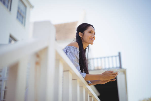 istock Thoughtful young woman holding a coffee cup 803513172
