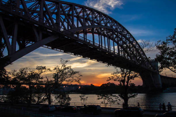 istock Hell Gate Bridge and in silhouette with sunset sky, New York 803519752