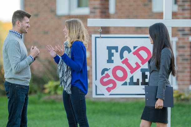 istock Real Estate Agent with Young Couple 803520046
