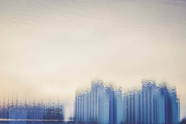 istock Blurred background of  office building with blue water reflection 803524320