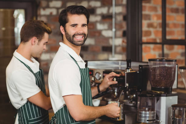 istock Two smiling baristas preparing coffee 803524650
