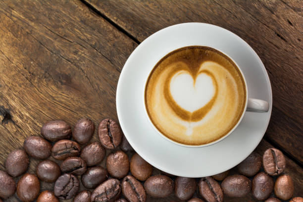 istock Latte art coffee and coffee beans on table 803527570