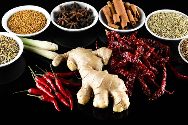 istock Mixed spice ginger, chilli, lemongrass, fenugreek, aniseed, anise, cinnamon over black background 803527602