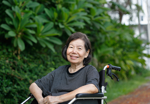 smiling elderly woman ,sitting on wheelchair
