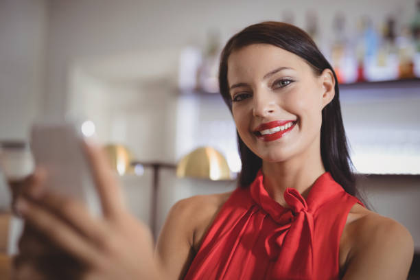 istock Portrait of beautiful woman using mobile phone 803551830