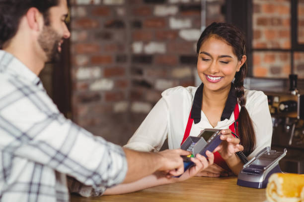 istock Smiling customer typing on the pin terminal 803559244