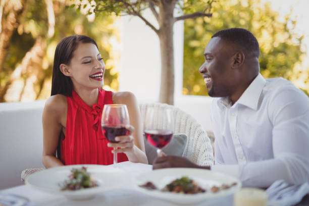 istock Romantic couple toasting their wine glasses 803574680