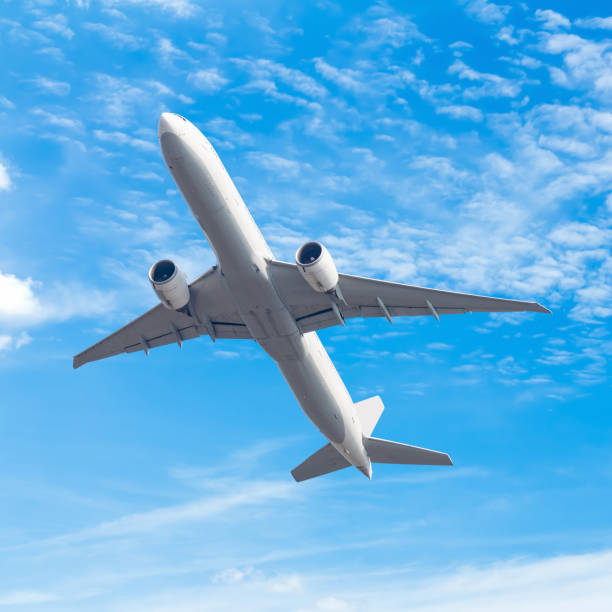 istock commercial airplane flying against blue sky background with clipping path 803577542