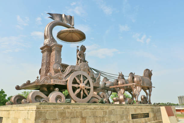 Kurukshetra, India - June 26, 2017: Giant Krishna-Arjuna chariot made of bronze metal, situated at Brahma Sarovar Kurukshetra, Haryana, is a big charm for the pilgrims.