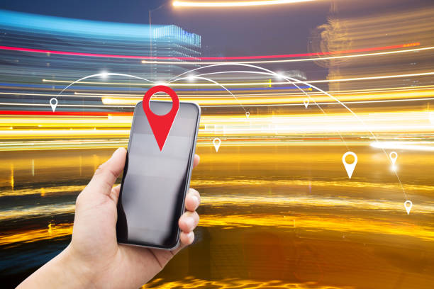 istock mobile phone with traffic on road at night 803580064