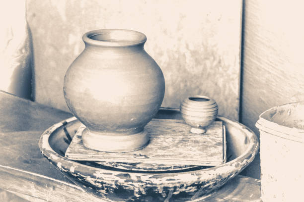 istock Old vintage style. Raw clay pots in potter's workshop 803587998