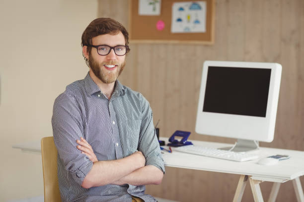 istock Happy hipster sitting at his desk 803588868