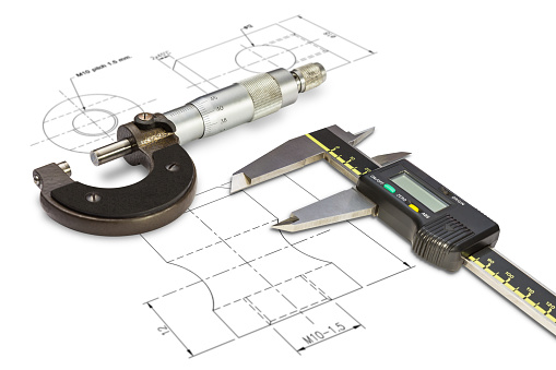 Micrometer and digital vernier calipers, isolated on drawing background with clipping path