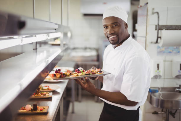 istock Chef holding dessert tray in commercial kitchen 803594440