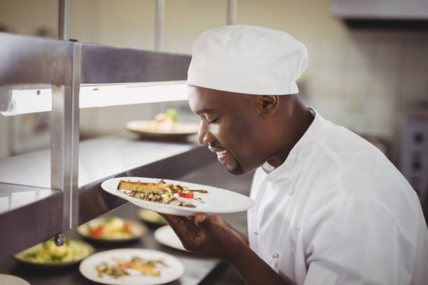 istock Chef smelling food in commercial kitchen 803594444