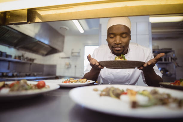 istock Chef smelling food in commercial kitchen 803594508