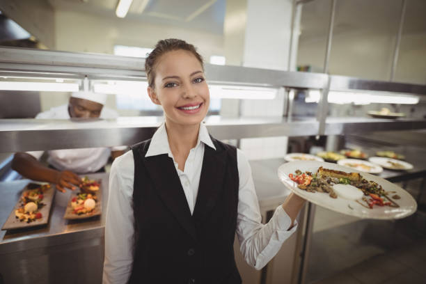 istock Waitress showing food dish to the camera 803594536