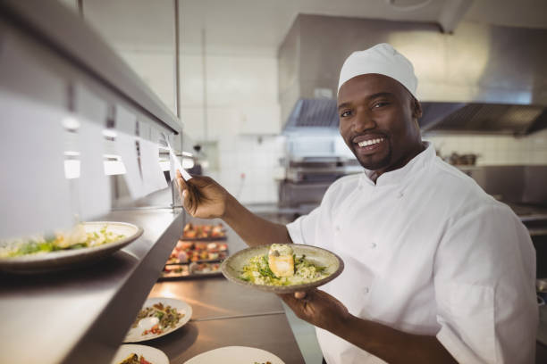 istock Chef standing at an order station in the commercial kitchen 803594622