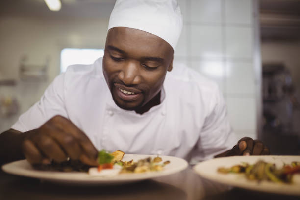 istock Chef garnishing meal on counter 803594634