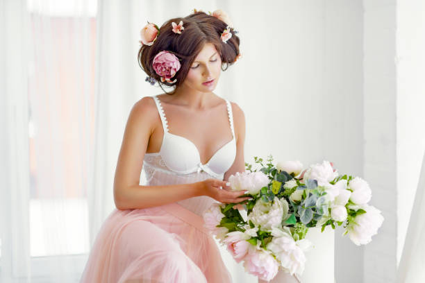 istock beautiful woman with white flowers on the head 803602596