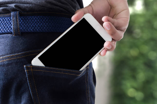 istock Young handsome poses hand Mobile Phone Pocket Communication Copy Space 803602768