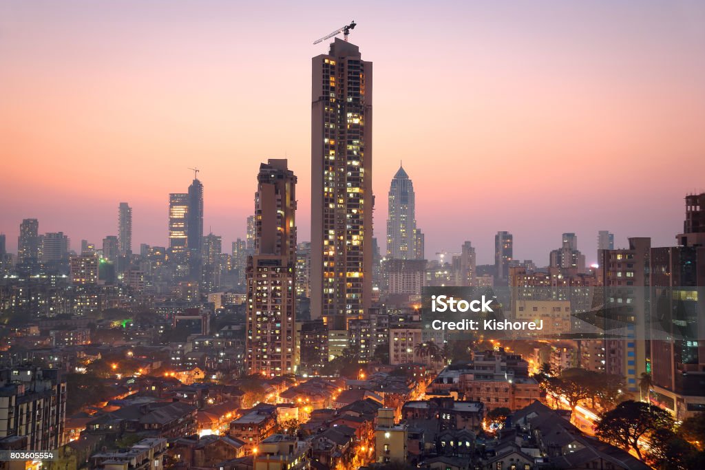 Panoramic view of south central Mumbai at golden hour (dusk) Panoramic view of south central Mumbai - the financial capital of India - at golden hour showing vast contrast in the living conditions of people with dwellings of lower middle class in foreground and towers where elite stay in the far background. Mumbai Stock Photo