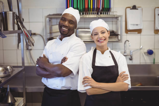 istock Two chefs standing with arms crossed in the commercial kitchen 803609420