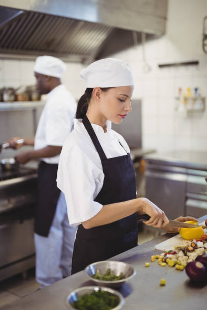 istock Female chefs chopping vegetables in the commercial kitchen 803609458