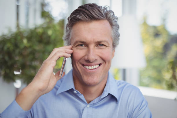 istock Businessman talking on mobile phone in restaurant 803611994