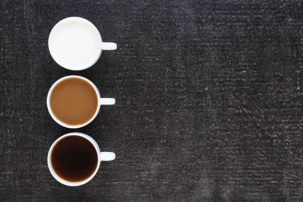 istock Three cups with coffee and milk on black background 803612648