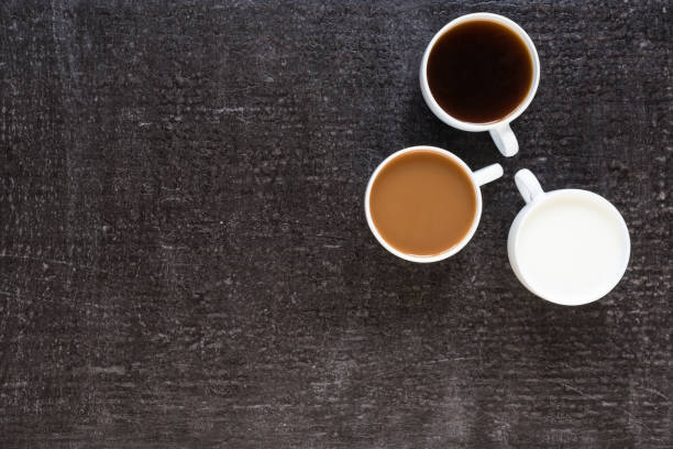 istock Three cups with coffee and milk on black background 803612774