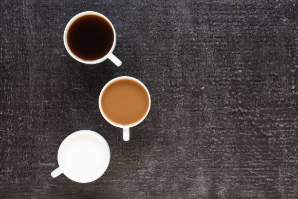 istock Three cups with coffee and milk on black background 803612810